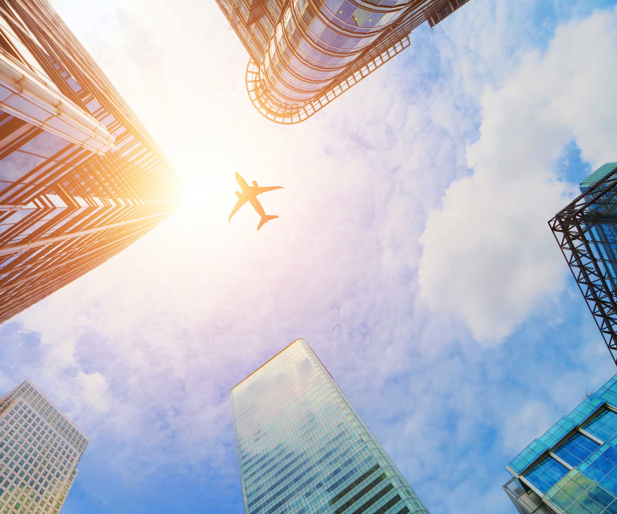 plane above skyscrapers